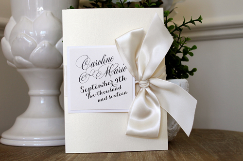 Invitation 1514: The feature of this invite is the beautiful large bow tied to the side.  The invite opens and there is a pocket on the left side, and the invitation wording on the right.