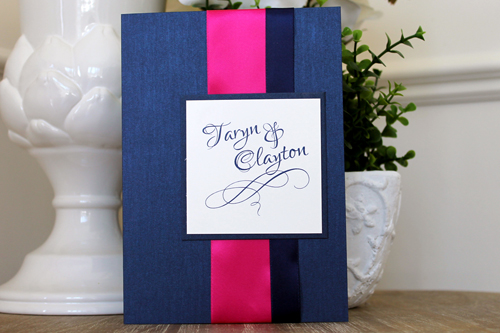 Invitation 1517: Navy Pearl, Navy Pearl, Cream Smooth, Azalea Ribbon, Navy Ribbon - This striking navy and magenta invite uses navy pearl as the folder paper and a thick azalea and thiner navy ribbon.