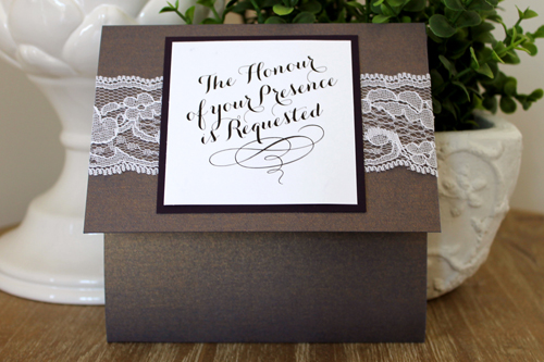 Invitation 1523: This vintage styled invite has a white lace around the front of the invite and a large square tag over it.  The invite opens vertically with a pocket inside.