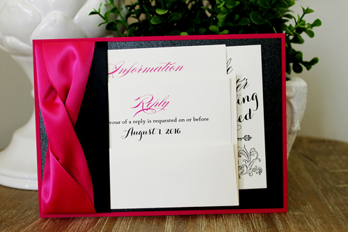Invitation 1524: This stunning azalea and pink invite is very bold with two thick azalea ribbons twisted together and a flat black ribbon below.  The paper is also a combination of azalea and black pearl.