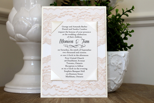 Invitation 1542: This is a classy vintage themed invite with very thick lace covering the card at the top and at the bottom.  The invitation wording is printed on a cream cardstock and is wrapped with corner ribbons.