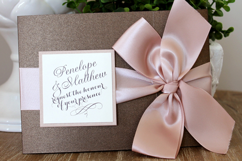 Invitation 1543: This is a chocolate brown invite that folds like a book and tied closed with a beautiful thick deep blush bow.  There is a pocket on the inside left and the invite wording on the right.