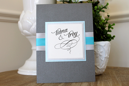 Invitation 1545: This invite card has a large cover tag that has three layers, using light blue and silver paper.  The ribbon is also a matching light silver thick ribbon with a turquoise ribbon on top.