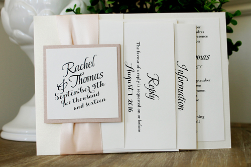 Invitation 1552: This is a popular invite design that prints on cream cardstock and backed onto a white gold pearl paper that folds on the left side with a ribbon and tag.