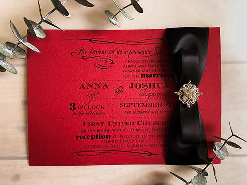 Invitation 1626: Red Lacquer, Red Lacquer, Black Ribbon, Black Ribbon, Brooch/Buckle A8 - This is a landscape orientation wedding invite on a red lacquer paper with a black ribbon and brooch no the right.