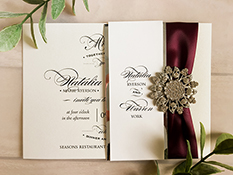 Invitation 1649: White Gold, White Gold, Silver Ribbon, Brooch/Buckle A11 - This is a single card wedding invite on white gold pearl.  There is silver mirror layered belly band with a ribbon and brooch.