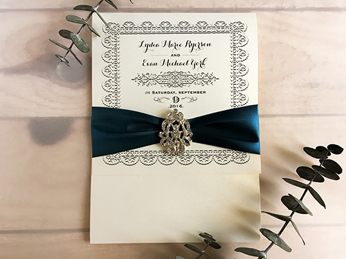 Invitation 1709: White Gold, White Gold, Teal Ribbon, Brooch/Buckle A17 - This is a 3/4 flap white gold pearl pocket folder wedding invite with a teal ribbon and brooch design.