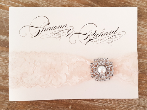 Invitation 1724: White Gold, White Gold, Cream Lace, Brooch/Buckle Q - This is a full flap white gold pearl wedding invitation pocket fold design.  There is a lace trim and brooch on the flap.