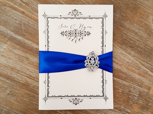 Invitation 1806: White Gold, White Gold, Royal Blue Ribbon, Brooch/Buckle A17 - This is a full cover flap pocketfolder wedding invite in white gold pearl.  There is a royal blue ribbon and brooch design.