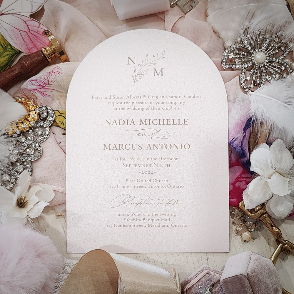 Invitation 2830: Light Pink Pearl - Arch shape cut wedding card on a pink paper with a monogram design printed at the top.