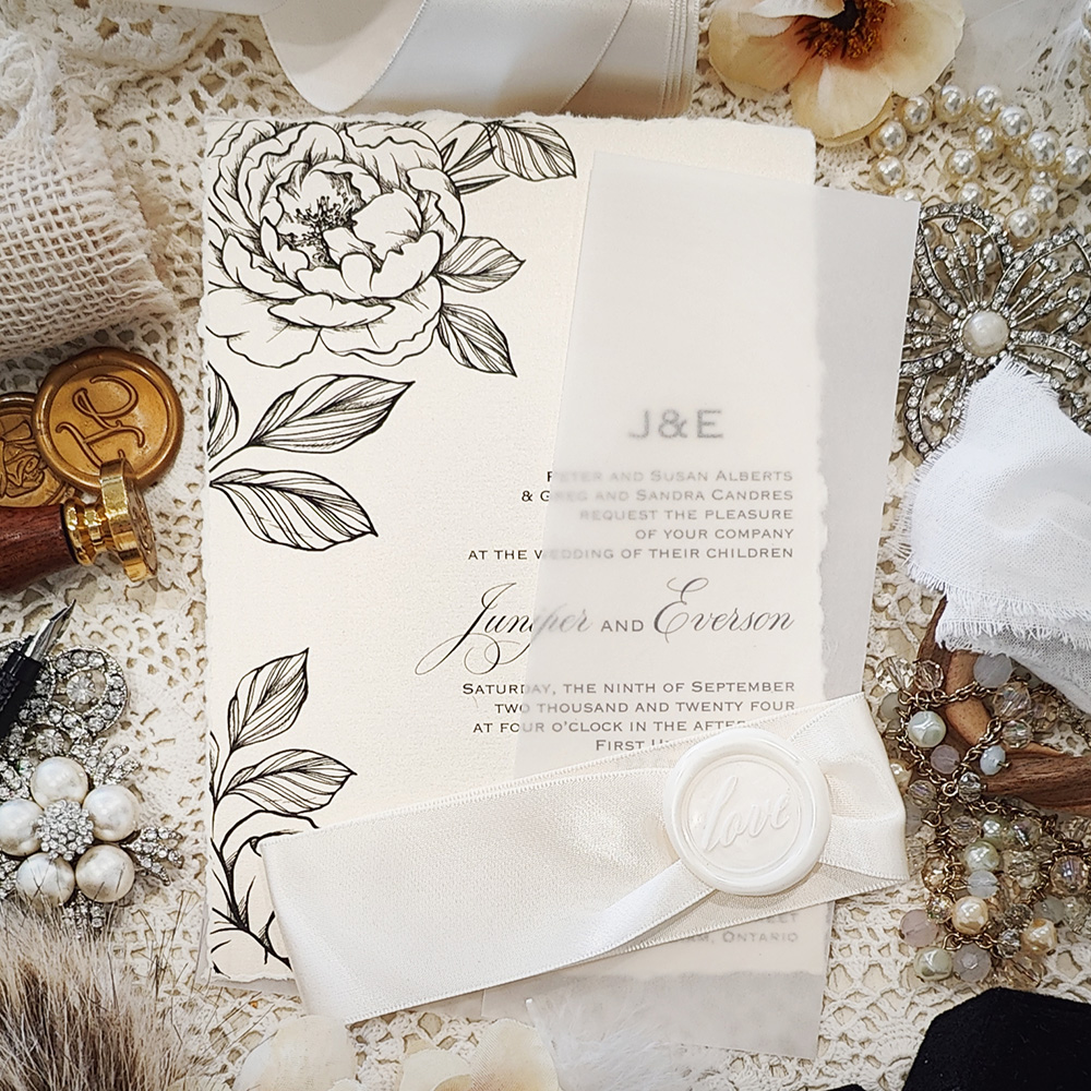 Invitation 3806: White Gold, Ivory Wax, Antique Ribbon - Deckle edge white gold pearl paper with custom floral print.  Clear vellum wrap with antique ribbon and ivory love wax seal.