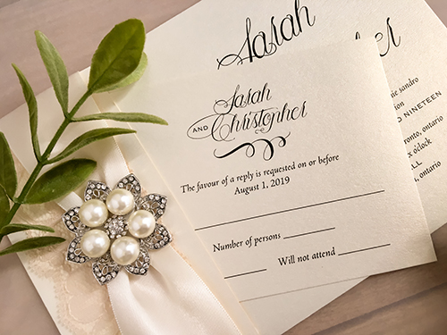 Invitation 2125: White Gold, Antique Ribbon, Cream Lace, Brooch/Buckle T - This is a folded over white gold pearl wedding invite.  There is an antique ribbon, cream lace and brooch on the design.