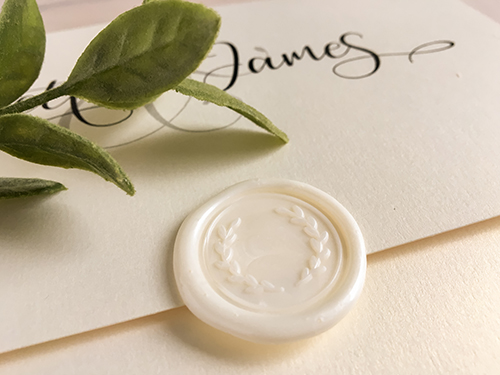 Invitation 2206: This is an invitation that opens up and down and has a wax seal on the cover.  It uses our white gold pearl paper and an ivory coloured stamp with a wreath print.