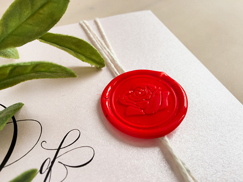 Invitation 2231: Opening left and right like a book, this wedding invitation is printed on our ice pearl paper and includes a white string wrapped around the card.  The wax seal provides a finishing touch.