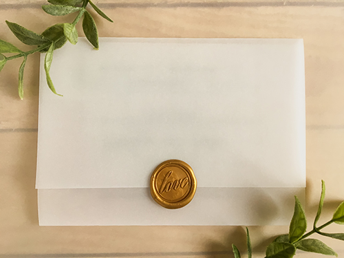 Invitation 2239: Gold Wax - This is a black ink printed vellum trifold with a gold wax seal with the love design imprinted.