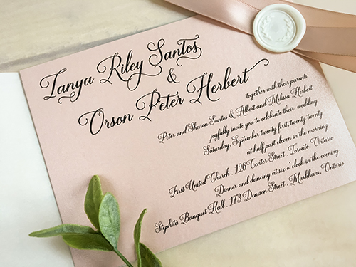 Invitation 2242: This is a single card invite in a landscape format printed on a blush pearl paper.  There is a vellum gate fold wrap with a blush ribbon and ivory wreath wax seal.