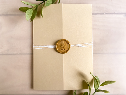 Invitation 2245: Champagne Gold, Gold Wax - This is a gate fold wedding invite in the champagne gold paper.  There is a string tied around the card with a gold branch wax seal.