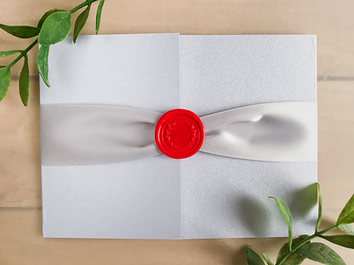 Invitation 2248: White Silver, Red Wax, Silver Ribbon - This is a landscape orientation card with a gate fold design.  There is a silver ribbon and red wreath wax seal.