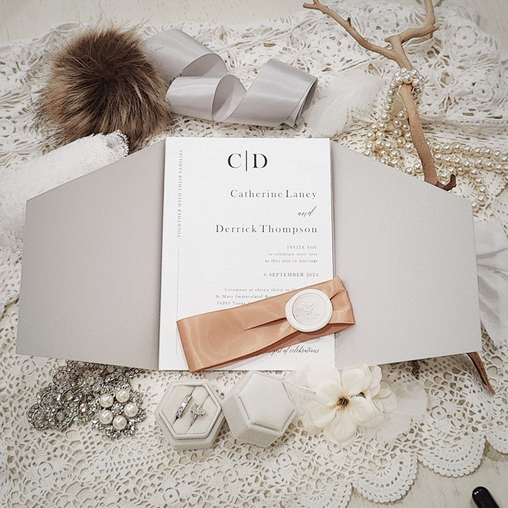 Invitation 3310: Silver Ore, Cream Smooth, Ivory Wax, Deep Blush Ribbon - Silver Ore slanted gate fold invite with a deep blush ribbon and ivory wax seal.