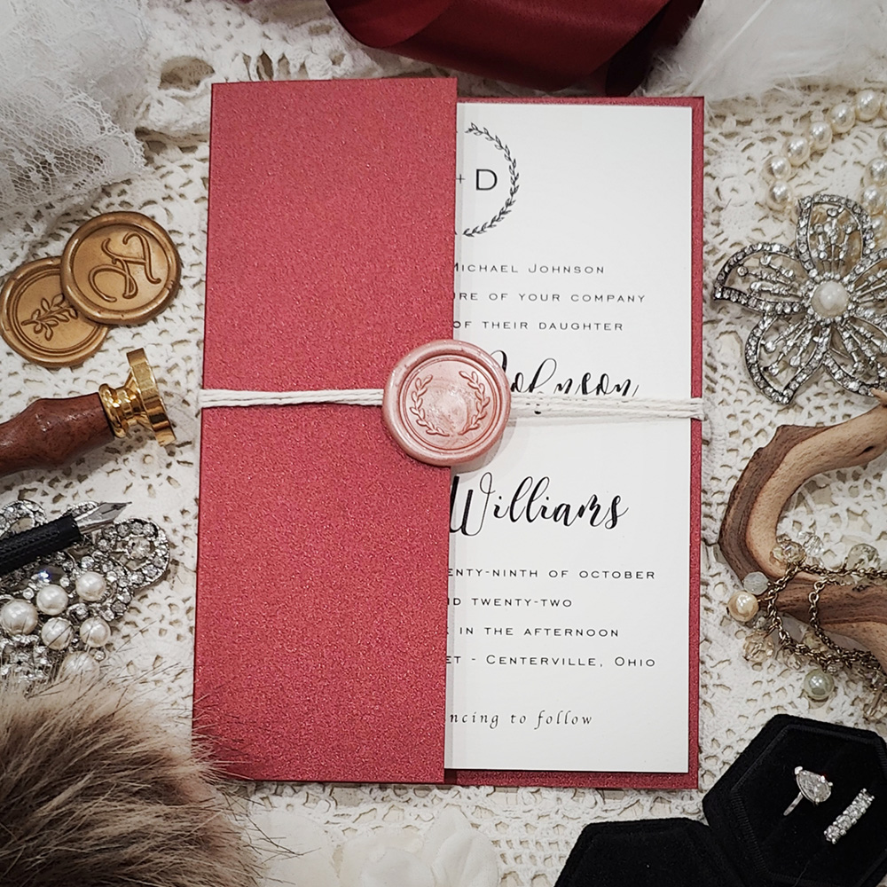 Invitation 3318: Red Lacquer, Cream Smooth, Blush Wax, String Ribbon - Half gate fold wedding invite in a red paper with a string and blush wreath wax seal.
