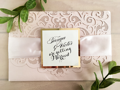Invitation lc101: Blush Shimmer, Gold Mirror, Cream Smooth, Petal Pink Ribbon - This is a blush shimmer laser cut pocketfolder wedding invite.  There is a petal pink ribbon and gold mirror layered cover tag on the flap.