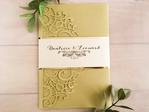 Invitation lc112: Metallic Gold, Gold Mirror, Cream Smooth - This is a metallic gold laser cut wedding invitation with a vellum belly band that has a gold mirror backing.