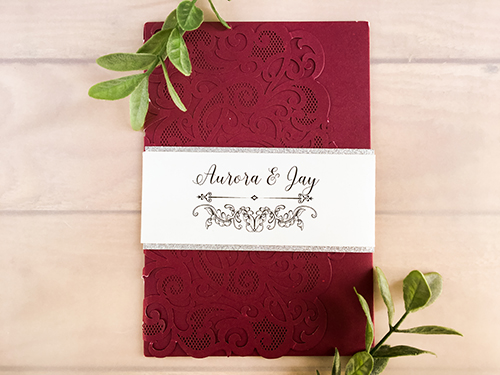 Invitation lc118: Burgundy Shimmer, Silver Glitter, Cream Smooth - This is a burgundy shimmer laser cut wedding invitation.  There is a silver glitter layered belly band wrapped around the card.