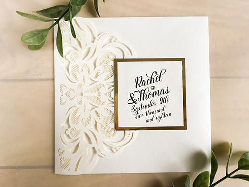 Invitation lc120: Ivory Shimmer, Gold Mirror, Cream Smooth, Brooch/Buckle Rhinestone - This is a classic ivory shimmer laser cut pocket folder wedding invite.  There a gold mirror layered cover tag.