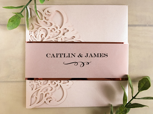 Invitation lc129: Blush Shimmer, Cream Smooth - This is a blush shimmer laser cut wedding invite with a vellum belly band with a rose gold mirror backing.