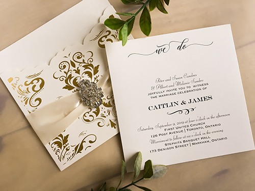 Invitation lc130: Ivory Shimmer, Cream Smooth, Antique Ribbon, Brooch/Buckle A17 - This is a gold foil printed laser cut pocket wedding invite.  There is an antique ribbon and brooch design.