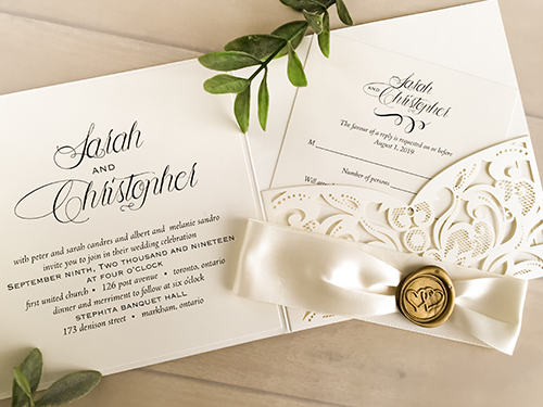 Invitation lc134: Ivory Shimmer, Cream Smooth, Gold Wax, Antique Ribbon - This is an ivory shimmer laser cut pocket folder wedding invite.  There is an antique ribbon with a gold double heart wax seal.