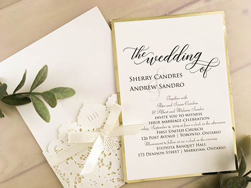 Invitation lc135: Ivory Shimmer, Gold Mirror, Cream Smooth, Antique Ribbon - This is an ivory shimmer laser cut pocket style wedding invite.  The main insert is layered with a gold mirror backing.  There is an antique bow.