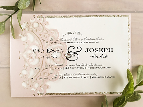 Invitation lc138: Blush Shimmer, Champagne Glitter, Cream Smooth - This is a blush shimmer laser cut pocket wedding invite that has the rhinestone gem on the tip.  The insert is loose with a champagne glitter backing.