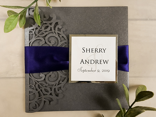 Invitation lc147: Grey Shimmer, Silver Mirror, Cream Smooth, Navy Ribbon - This is a grey shimmer pocket folder laser cut invitation.  There is a navy ribbon and cover tag wrapped around the invite.