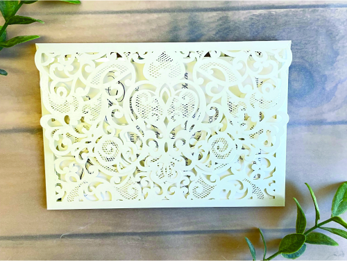 Invitation lc154: Ivory Shimmer, Silver Mirror, Cream Smooth - This is an ivory shimmer laser cut invitation with a very intricate design patter on the flap.  The main layout has a silver mirror backing.