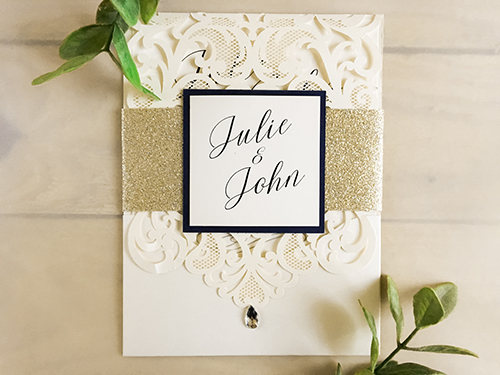 Invitation lc25: This is a pocket style laser cut wedding invitation in the ivory shimmer color.  There is a champagne glitter band with a white gold backing on the cover tag.