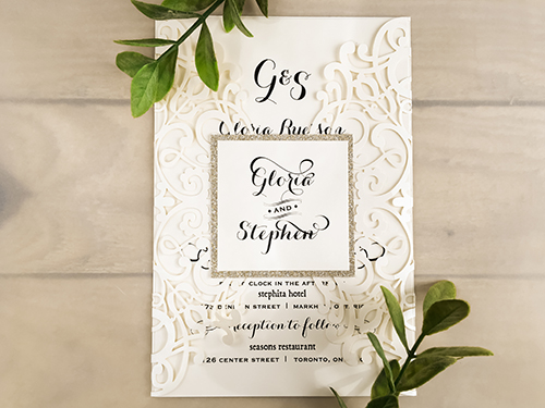 Invitation lc26: Ivory Shimmer, Champagne Glitter, Cream Smooth - This is an ivory shimmer gate fold laser cut wedding card.  The cover tag has a champagne glitter paper backing.