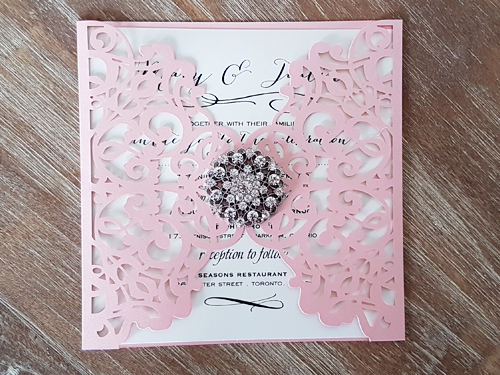 Invitation lc35: Pink Shimmer, Cream Smooth, Brooch/Buckle X - This is a pink shimmer pattern laser cut wedding invitation.  There is a rhinestone brooch glued in the center.
