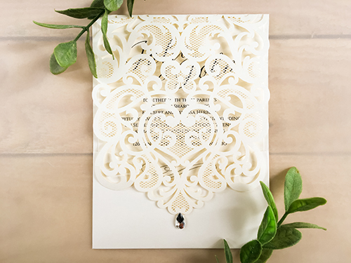 Invitation lc3: Ivory Shimmer, Cream Smooth - Portrait style laser cut invitation, in ivory shimmer. Available in a variety of colours. Comes made with a rhinestone.