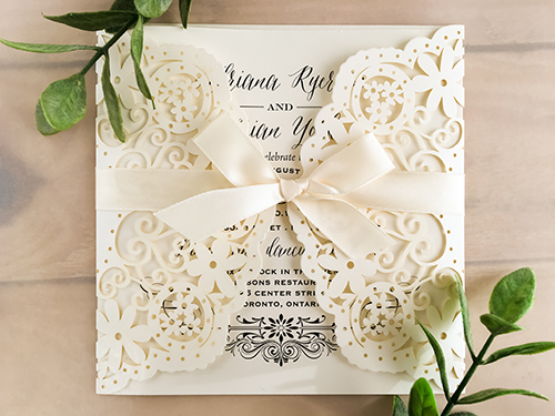 Invitation lc42: Glittering Ivory, Cream Smooth, Antique Ribbon - This is a glittering ivory laser cut wedding card that has a gate fold design.  There is a 5/8 antique bow tied around the card.