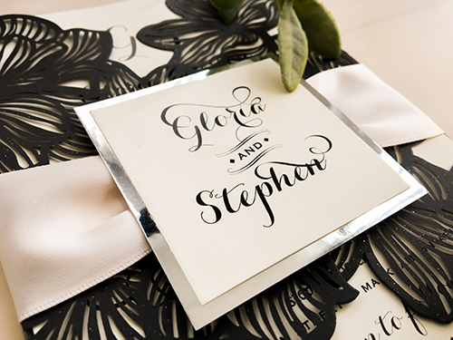 Invitation lc47: Glittering Black, Silver Mirror, White Ribbon - This is a glittering black gate fold floral pattern laser cut wedding invitation.  There is a white ribbon and silver mirror layered cover tag.