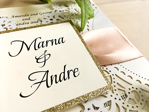 Invitation lc60: White Shimmer, Champagne Glitter, Cream Smooth, Deep Blush Ribbon - This is a white shimmer laser cut gate fold wedding invitation.  There is a champagne glitter layered cover tag with deep blush ribbon.