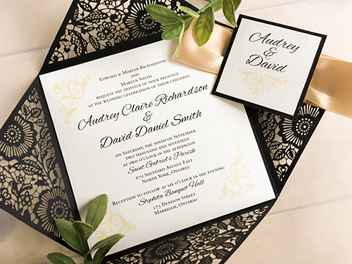 Invitation lc65: Glittering Black, Black Glitter, Cream Smooth, Champagne Ribbon - This is a glittering black four flap laser cut wedding invite.  There is a champagne ribbon tied around with a black glitter cover tag.