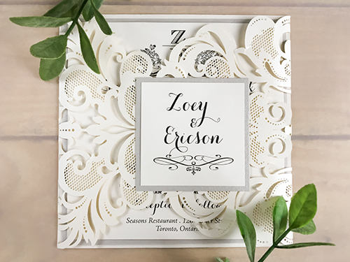 Invitation lc66: This is an ivory shimmer gate fold laser cut wedding invitation.  The cover tag has a silver ore backing.  The main layout has an extra silver ore layer.