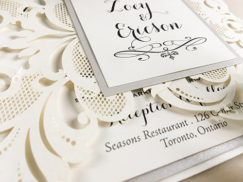 Invitation lc66: This is an ivory shimmer gate fold laser cut wedding invitation.  The cover tag has a silver ore backing.  The main layout has an extra silver ore layer.