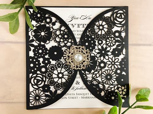 Invitation lc71: Glittering Black, Cream Smooth, Brooch/Buckle Q - This is a glittering black laser cut wedding card.  There is a pearl brooch on the center of the cover.