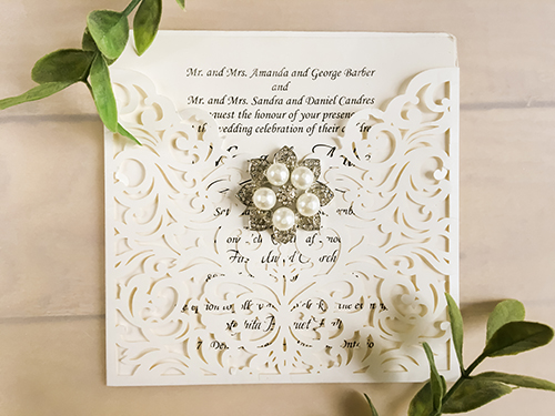 Invitation lc79: Ivory Shimmer, Brooch/Buckle T - This is an ivory shimmer pocket style laser cut wedding invite.  There is a five pearl rhinestone brooch on the front.