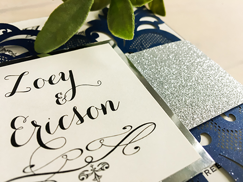 Invitation lc7: Baroque inspired laser cut wedding invitation in a deep glittering navy, with glitter wrap around belly band and a cover tag, backed with mirror paper.