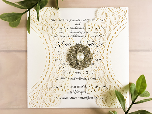 Invitation lc87: Ivory Shimmer, Cream Smooth, Brooch/Buckle A6 - This is a ivory shimmer gate fold pattern laser cut wedding card.  There is a rhinestone pearl brooch.