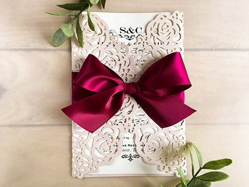 Invitation lc88: Blush Shimmer, Cream Smooth, Wine Ribbon - This is a blush shimmer laser cut gate fold wedding invite.  There is a large wine bow tied around.